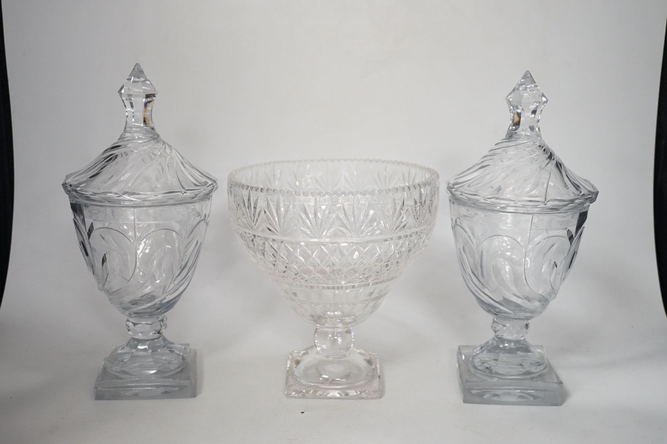 A pair of Regency Irish cut glass sweetmeat vases and covers, 30cm high and an Edwardian cut glass pedestal vase (3)